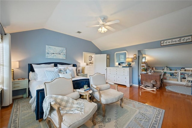 bedroom with visible vents, wood finished floors, and lofted ceiling