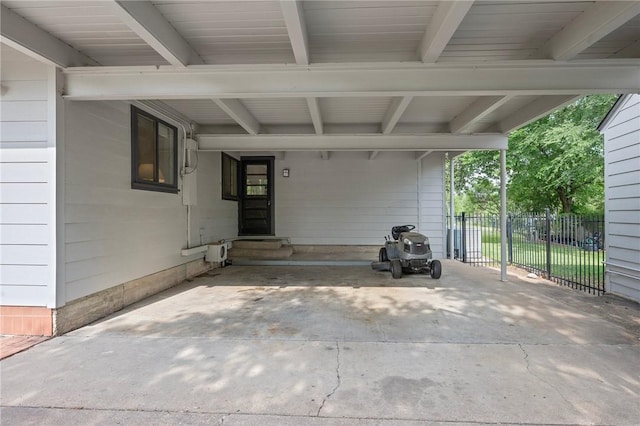 view of patio with entry steps, an attached carport, and fence