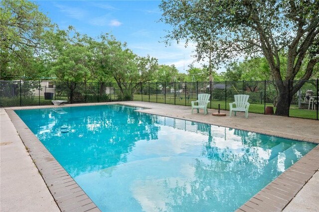 view of swimming pool with fence, a fenced in pool, and a patio area