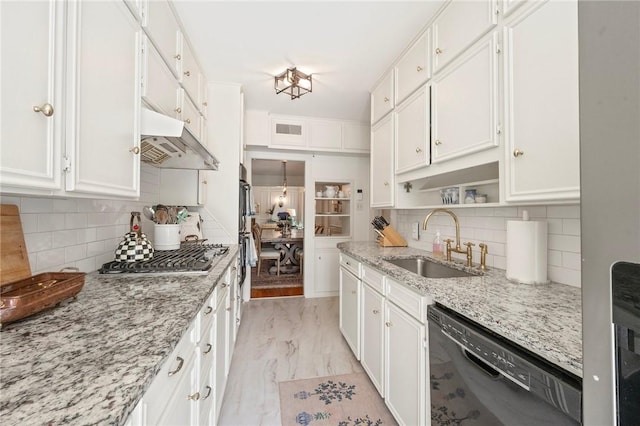 kitchen featuring black dishwasher, stainless steel gas stovetop, backsplash, and a sink