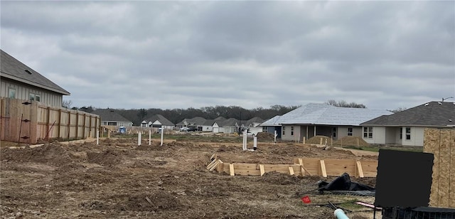 view of yard featuring fence and a residential view