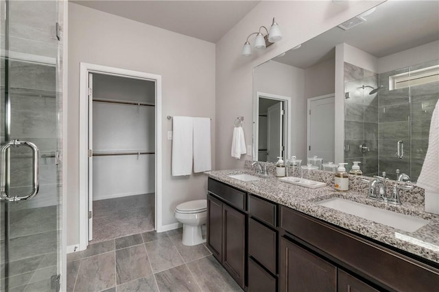 5308 Lyle Pl, Bryan, TX 77807 - full bath featuring a stall shower, double vanity, toilet, a spacious closet, and baseboards