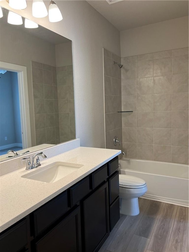 5308 Lyle Pl, Bryan, TX 77807 - full bathroom with vanity, wood finished floors, toilet, and shower / bathtub combination