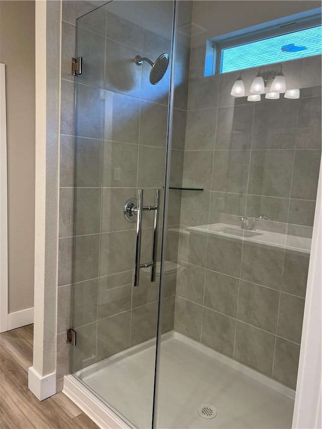 5308 Lyle Pl, Bryan, TX 77807 - bathroom with a shower stall, wood finished floors, and baseboards