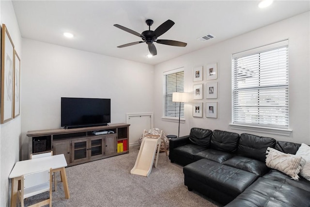 living room featuring ceiling fan and carpet flooring