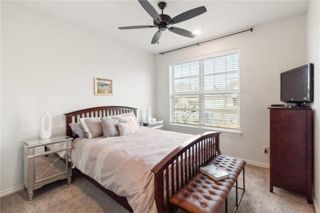 bedroom with light carpet and ceiling fan