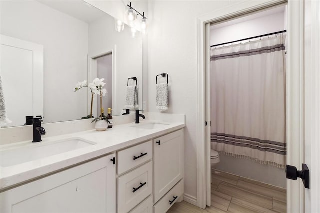 bathroom featuring hardwood / wood-style flooring, vanity, and toilet