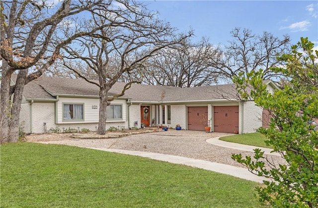 ranch-style house with a garage and a front yard