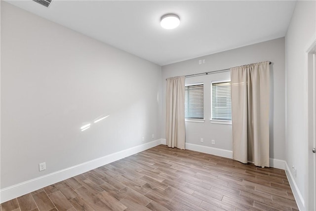 unfurnished room with light wood-type flooring