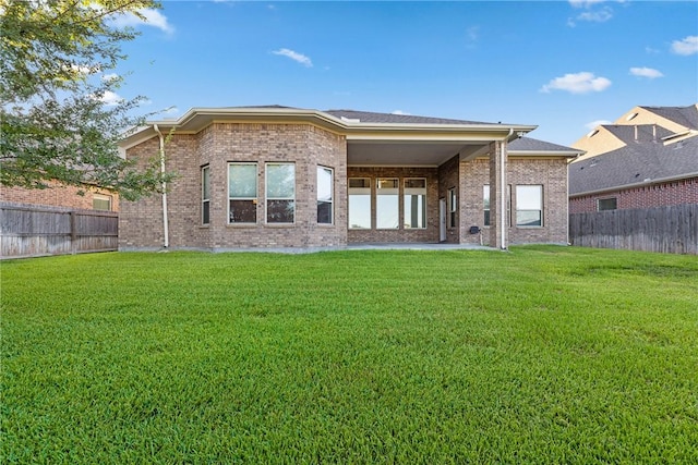 back of house featuring a lawn