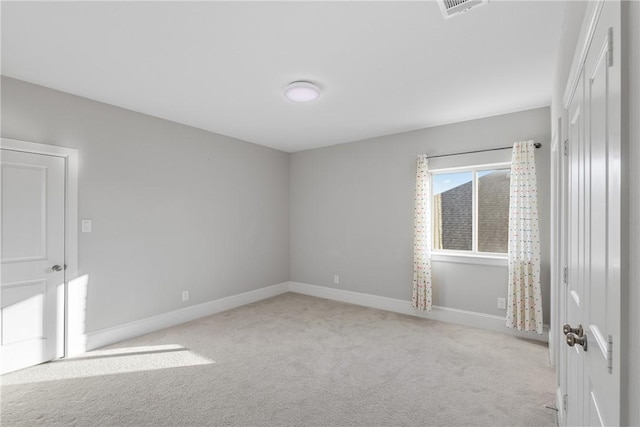 unfurnished room featuring light colored carpet