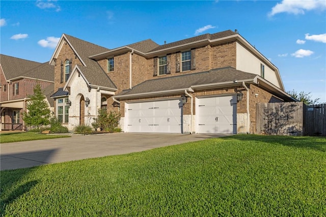 view of front of home with a front yard and a garage