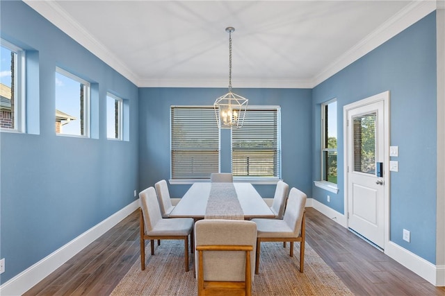 dining space featuring a notable chandelier, dark hardwood / wood-style floors, and crown molding