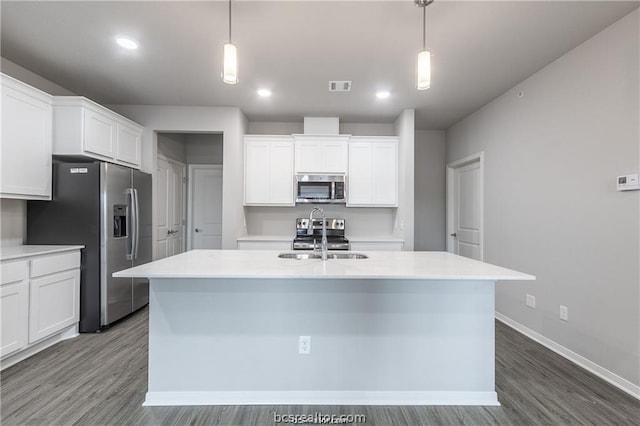 kitchen featuring stainless steel appliances, white cabinetry, and hanging light fixtures