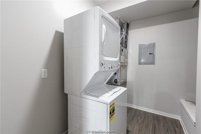 laundry room featuring dark hardwood / wood-style flooring, electric panel, and stacked washer and clothes dryer