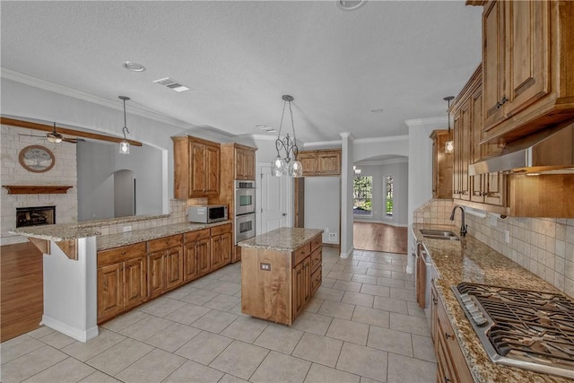 kitchen featuring tasteful backsplash, ornamental molding, stainless steel appliances, a center island, and a breakfast bar area