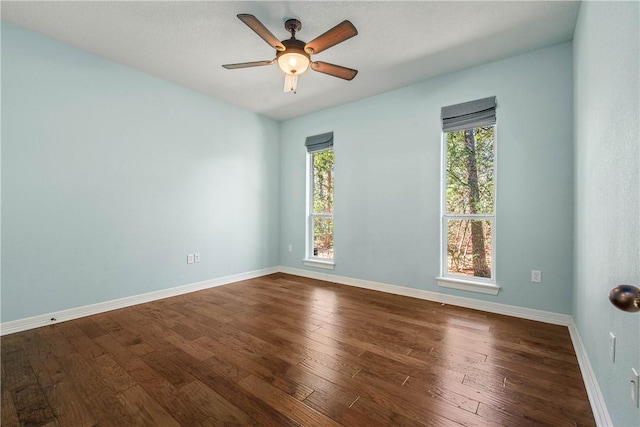 empty room with hardwood / wood-style flooring and ceiling fan