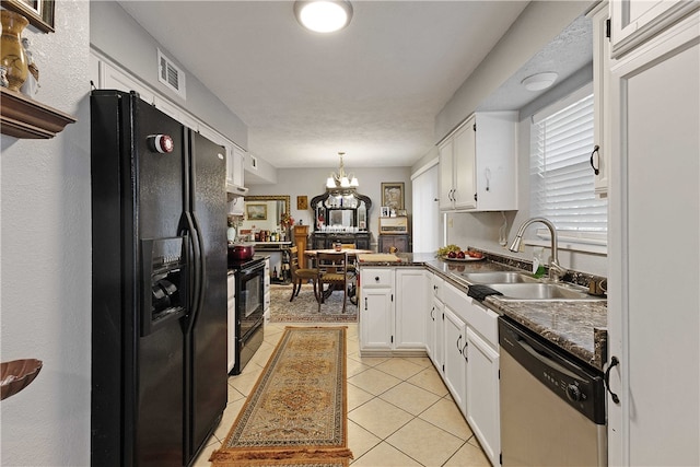 kitchen with sink, black appliances, decorative light fixtures, a notable chandelier, and white cabinetry