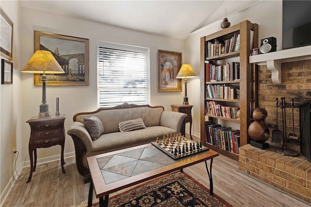 living area with light hardwood / wood-style floors and lofted ceiling