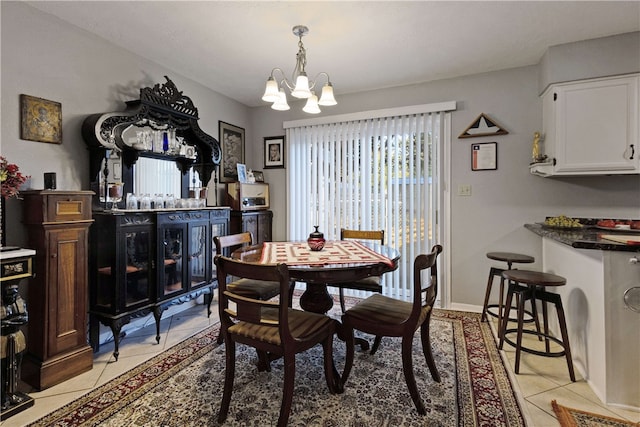 tiled dining room featuring a notable chandelier