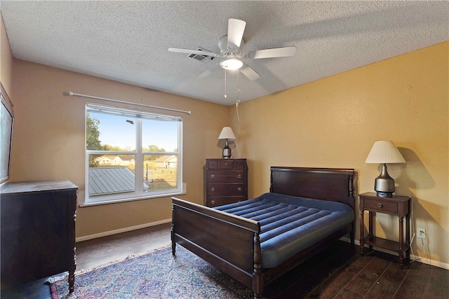 bedroom featuring a textured ceiling, ceiling fan, and dark wood-type flooring