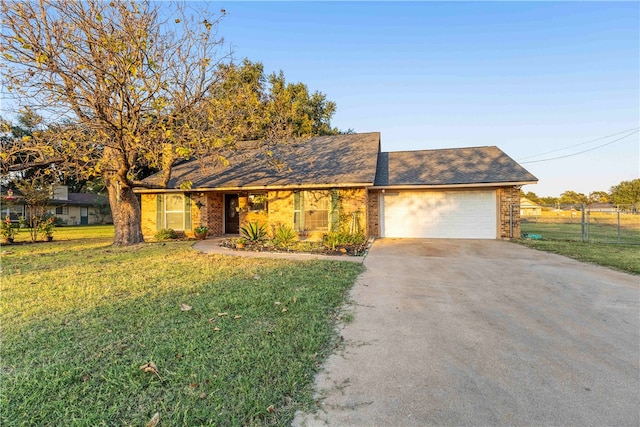 single story home with a front yard and a garage