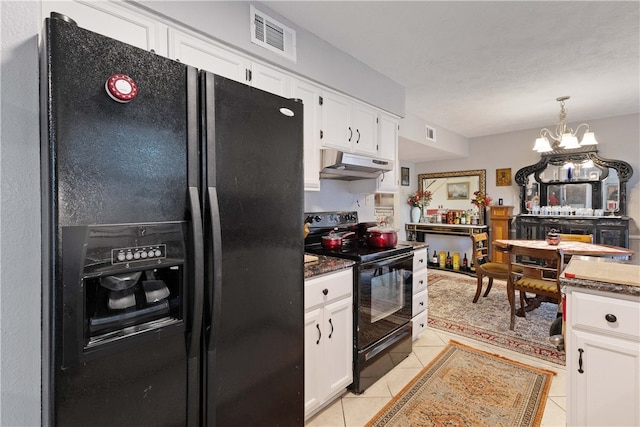 kitchen with white cabinets, light tile patterned floors, an inviting chandelier, and black appliances