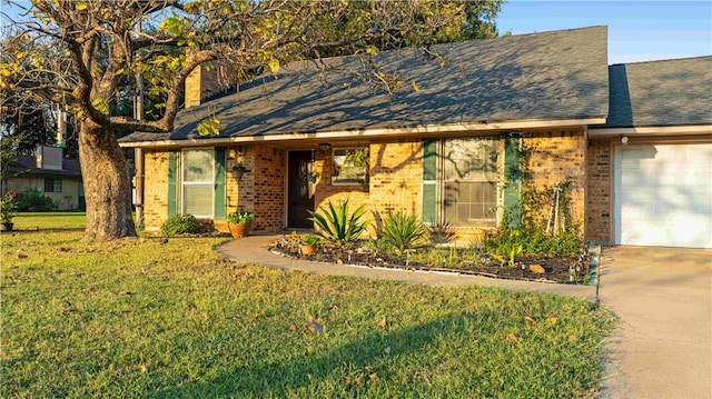 view of front of house with a front yard and a garage