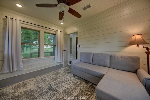 living room featuring wooden walls, ceiling fan, and wood ceiling