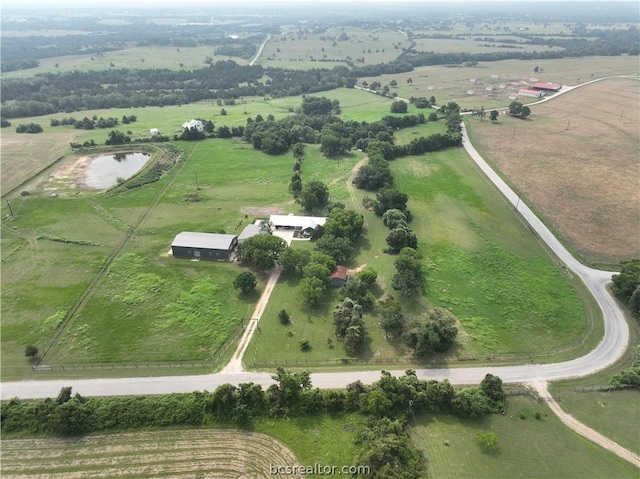 birds eye view of property with a rural view