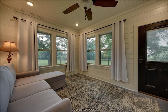 sunroom featuring a wealth of natural light, ceiling fan, and wooden ceiling