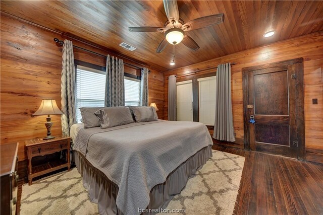 bedroom featuring wood ceiling, light hardwood / wood-style flooring, ceiling fan, and wood walls