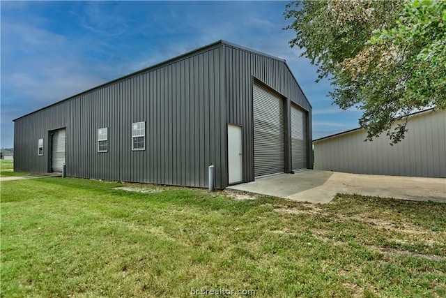 view of outdoor structure with a yard and a garage