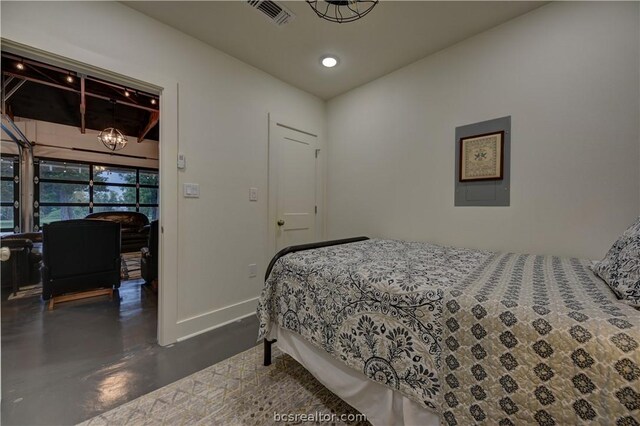 bedroom featuring a notable chandelier