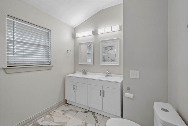 1001 Esther Blvd, Bryan, TX 77802 - bathroom with toilet, marble finish floors, lofted ceiling, double vanity, and baseboards