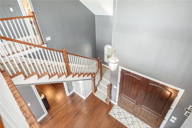 staircase with hardwood / wood-style floors