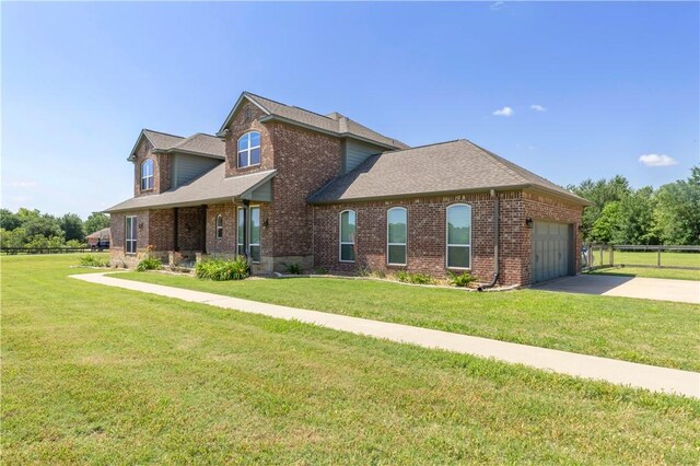 18214 Retriever Run, College Station, TX 77845 - view of front of home with brick siding, concrete driveway, an attached garage, and roof with shingles