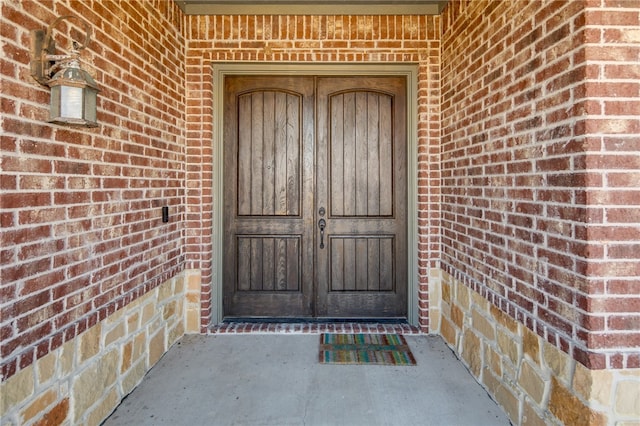 entrance to property with brick siding