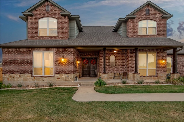 18214 Retriever Run, College Station, TX 77845 - view of front of property with roof with shingles, brick siding, and a front lawn