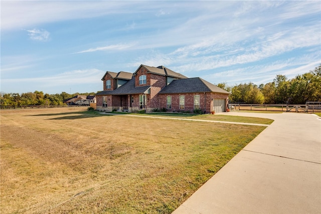 view of front of home with a front lawn and a garage