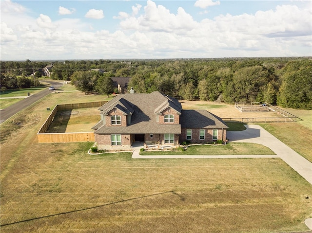 birds eye view of property with a view of trees