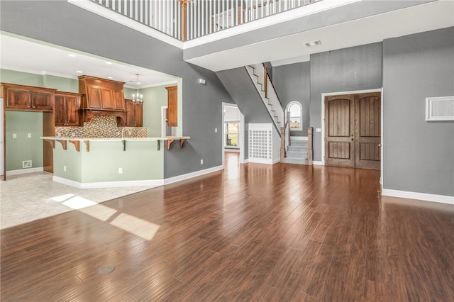 kitchen featuring sink, decorative backsplash, light stone countertops, ornamental molding, and appliances with stainless steel finishes