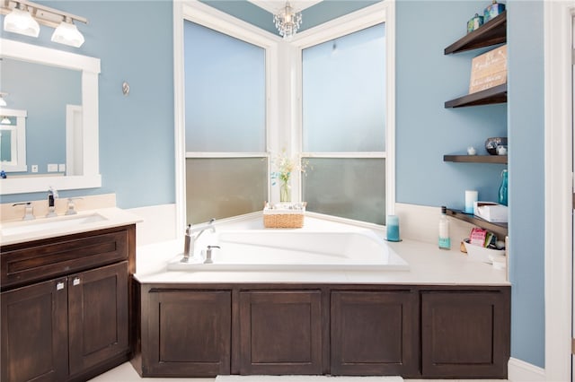 bathroom with vanity, a bath, and an inviting chandelier