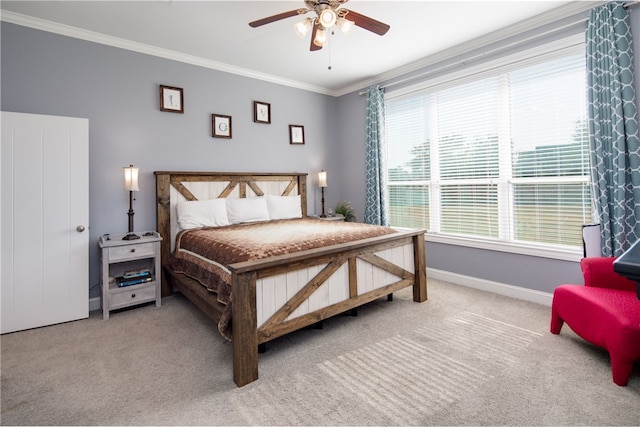 bedroom with carpet flooring, ceiling fan, and crown molding