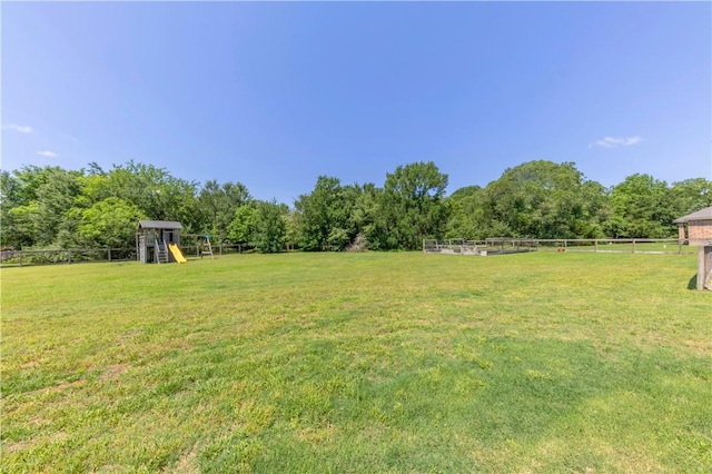 18214 Retriever Run, College Station, TX 77845 - view of yard with a playground and a wooded view