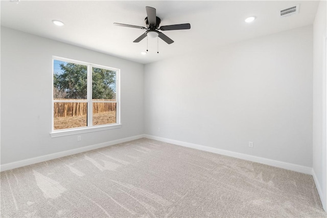 unfurnished room with recessed lighting, light carpet, visible vents, and baseboards