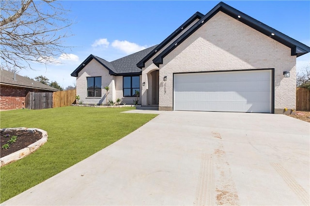 view of front of house with concrete driveway, a front lawn, an attached garage, and fence