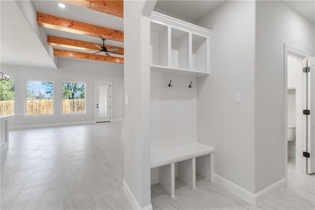 mudroom featuring ceiling fan with notable chandelier, beam ceiling, and baseboards