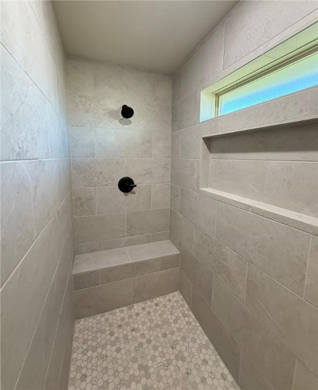 bathroom with a tile shower