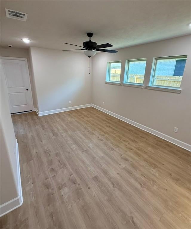 spare room featuring ceiling fan and light hardwood / wood-style floors